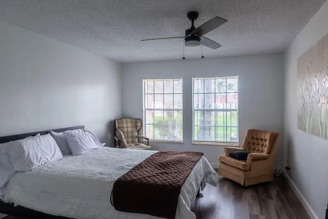 a bedroom with a bed and a couch