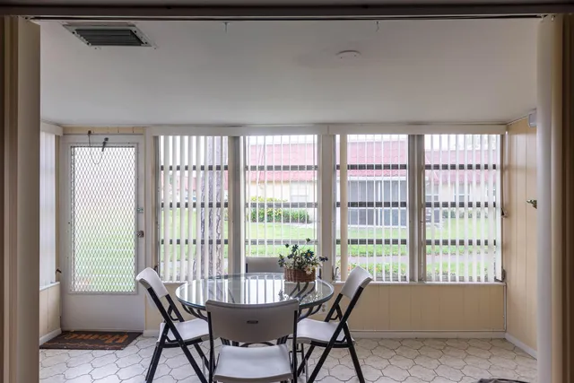 a view of a dining room with furniture and a window
