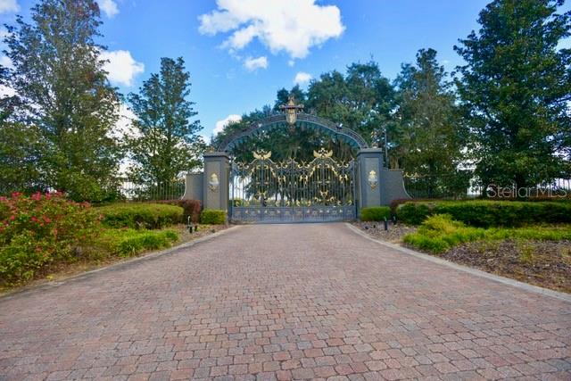 11750 Southeast 22nd Ave Road Ocala, FL 34480 - Photo 4 of 5 a sidewalk with a trees in the background