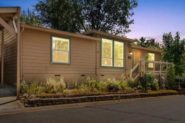 a front view of a house with a garden