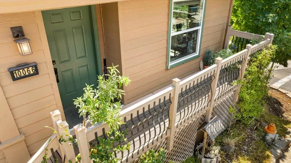 a view of a house with a small yard and plants