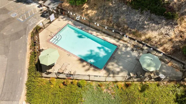 an aerial view of residential houses with outdoor space and trees