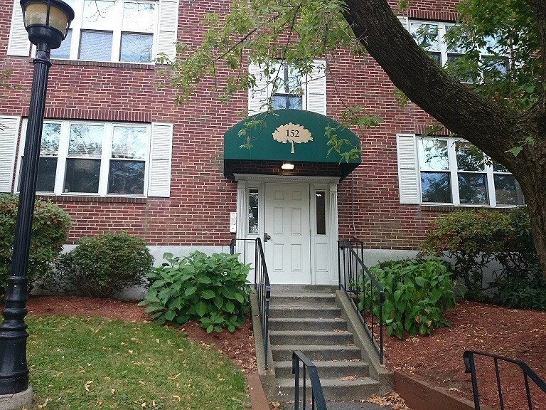 152 Newton Street, Unit 4 Boston, MA 02135 - Photo 1 of 11 a front view of a house with a yard