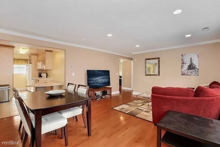 152 Newton Street, Unit 4 Boston, MA 02135 - Photo 2 of 11 a living room with furniture and a flat screen tv