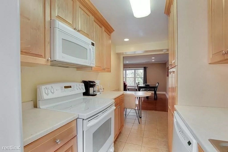 152 Newton Street, Unit 4 Boston, MA 02135 - Photo 4 of 11 a kitchen with a stove and a refrigerator
