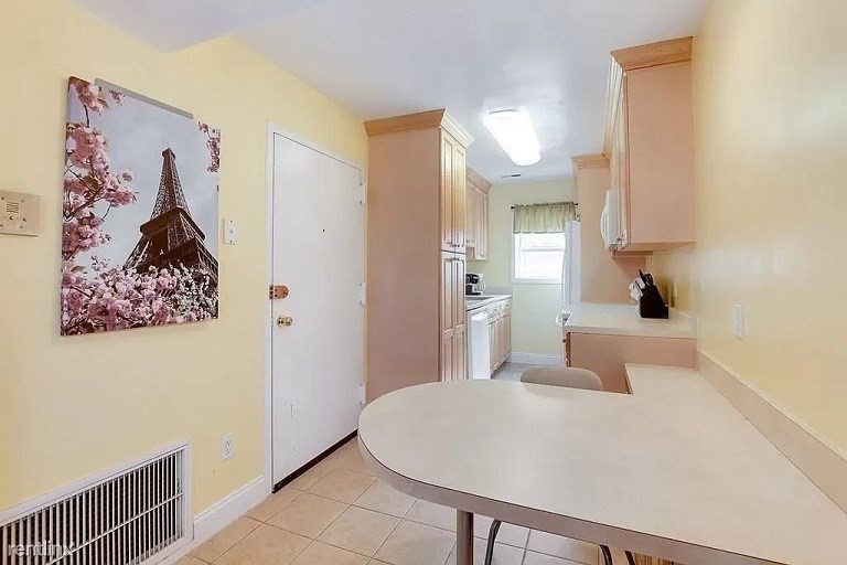 152 Newton Street, Unit 4 Boston, MA 02135 - Photo 5 of 11 a bedroom with a large bed and a chandelier