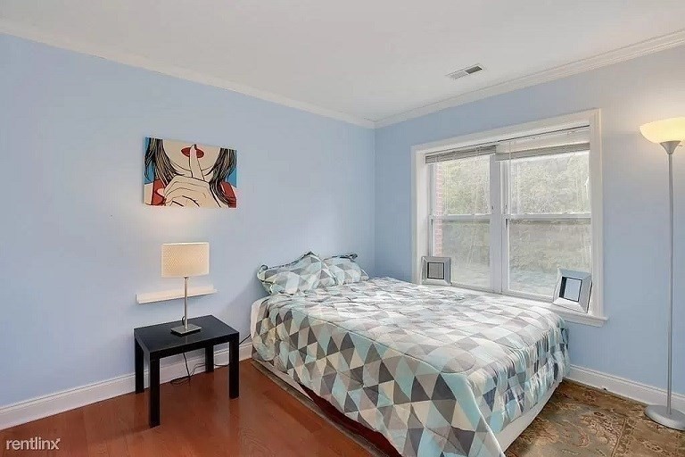 152 Newton Street, Unit 4 Boston, MA 02135 - Photo 6 of 11 a bedroom with a bed and a window