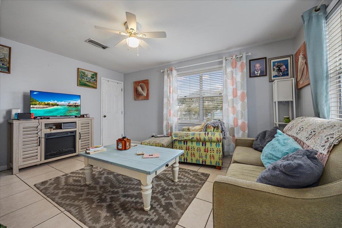 111 A Street St. Augustine Beach, FL 32080 - Photo 11 of 17 a living room with furniture a flat screen tv and a fireplace