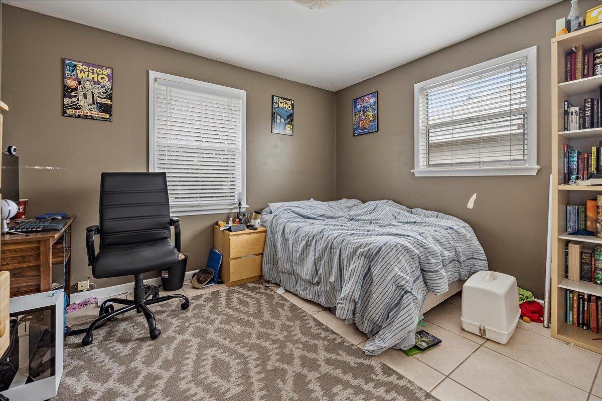 111 A Street St. Augustine Beach, FL 32080 - Photo 12 of 17 a bedroom with a bed and a desk