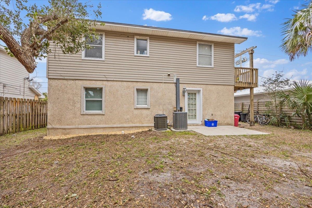 111 A Street St. Augustine Beach, FL 32080 - Photo 15 of 17 a view of a house with a backyard and a garage