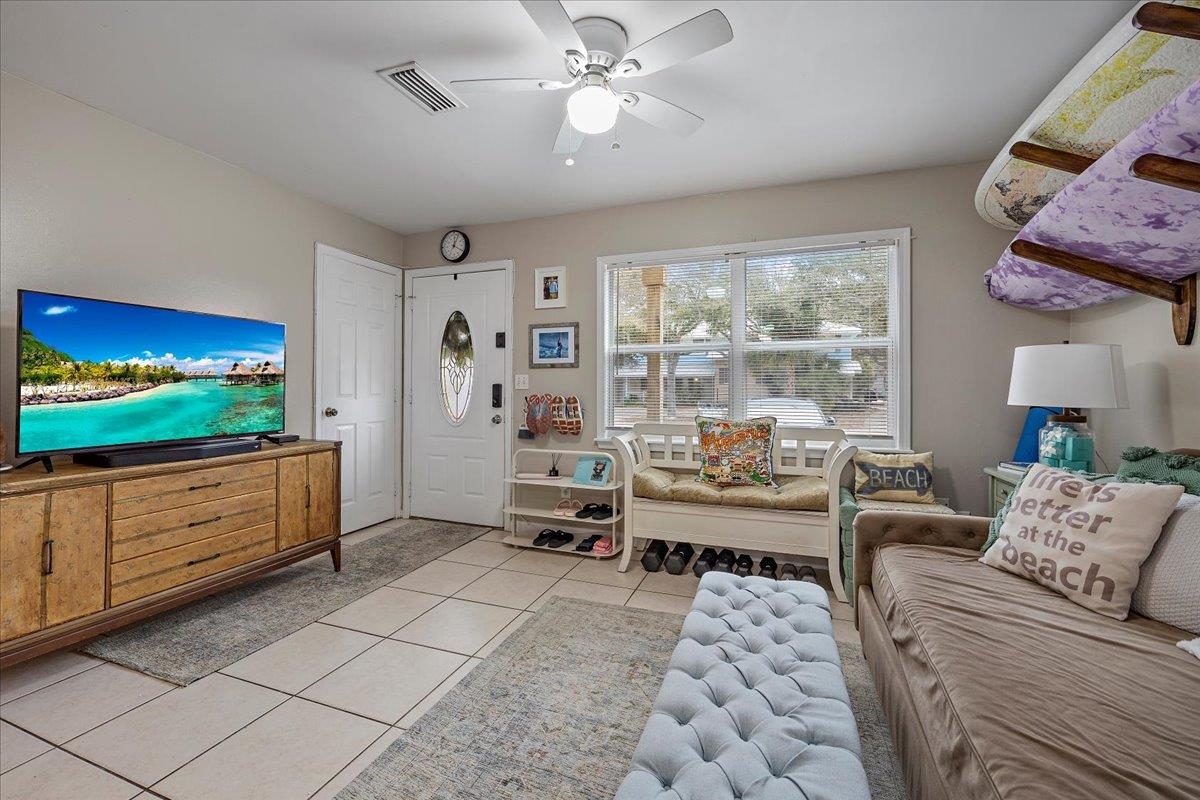 111 A Street St. Augustine Beach, FL 32080 - Photo 3 of 17 a living room with furniture and a flat screen tv