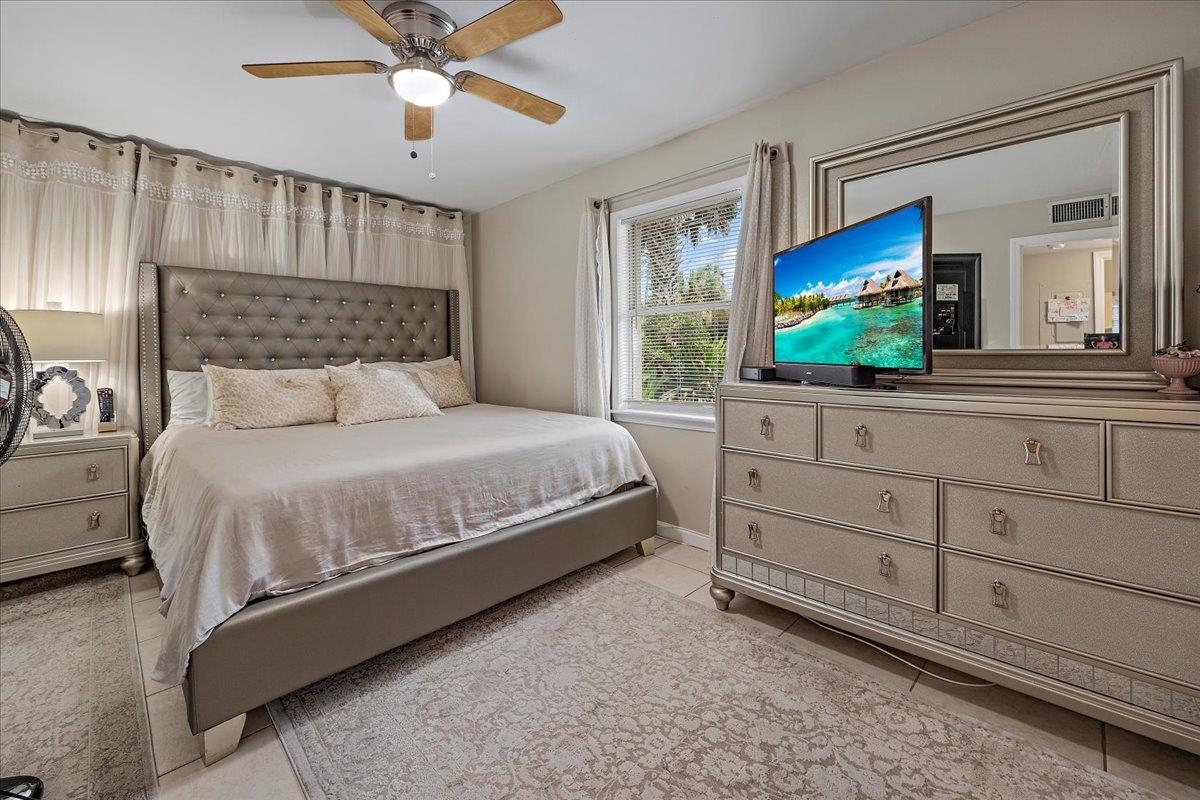 111 A Street St. Augustine Beach, FL 32080 - Photo 7 of 17 a bedroom with a large bed and a flat screen tv