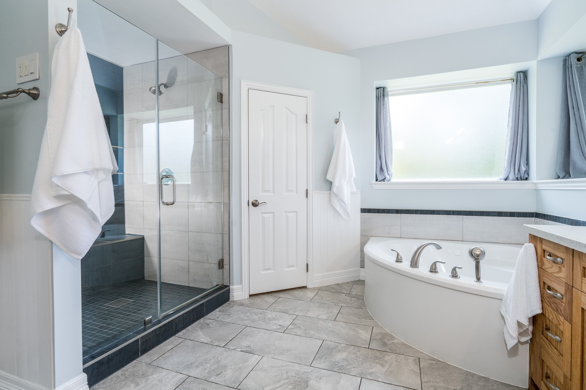 5914 Oakmoss Trail Spring, TX 77379 - Photo 16 of 50 The spa-like primary bath boasts an oversized shower with body sprayers, bench and don't miss the whirlpool tub awaiting you to come unwind after a long day.