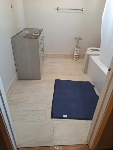 a room with water heater and a wooden floor