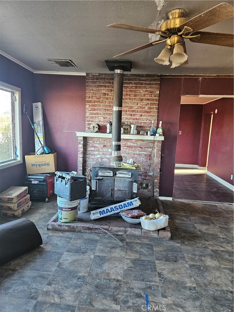 2352 Jacks Ranch Road Ridgecrest, CA 93555 - Photo 25 of 33 a living room with furniture a fireplace and a chandelier