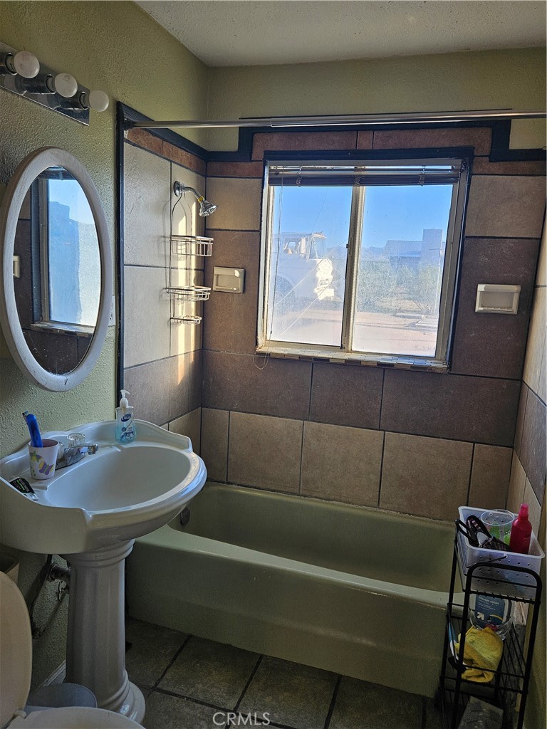 2352 Jacks Ranch Road Ridgecrest, CA 93555 - Photo 26 of 33 a bathroom with a sink and a mirror