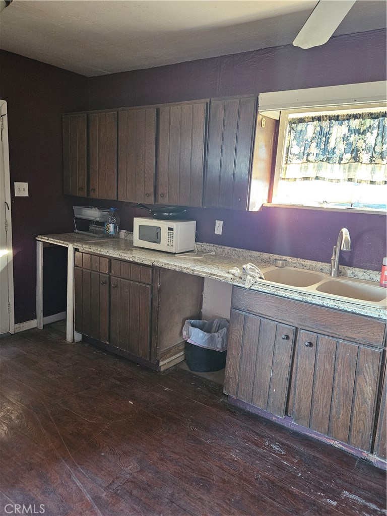 2352 Jacks Ranch Road Ridgecrest, CA 93555 - Photo 30 of 33 a kitchen with a sink stove and cabinets