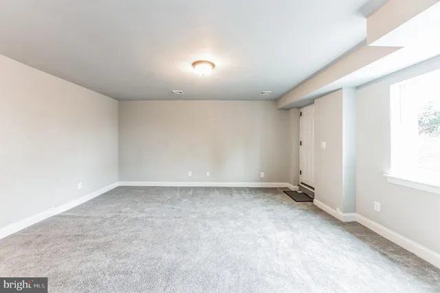 an empty room with a empty space and windows