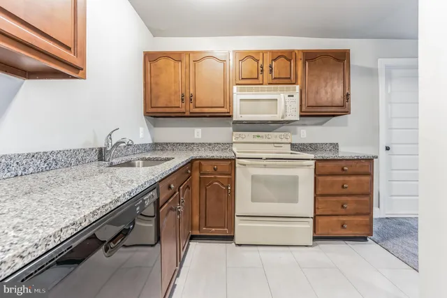 a kitchen with stainless steel appliances granite countertop a sink and cabinets