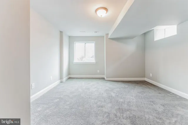 an empty room with a empty space and windows