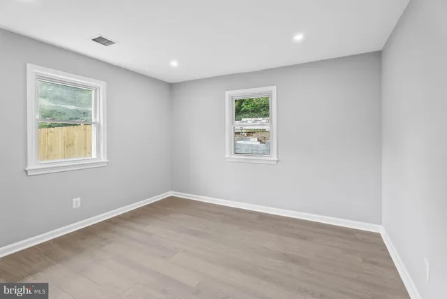 an empty room with windows and closet