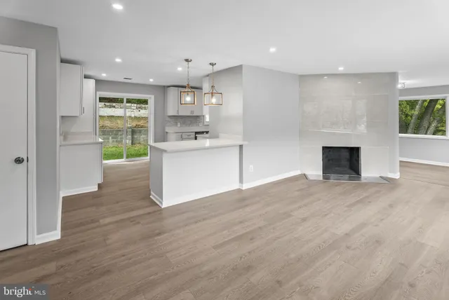 a view of a kitchen with wooden floor and a sink