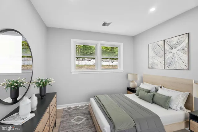 a bedroom with a bed and a potted plant