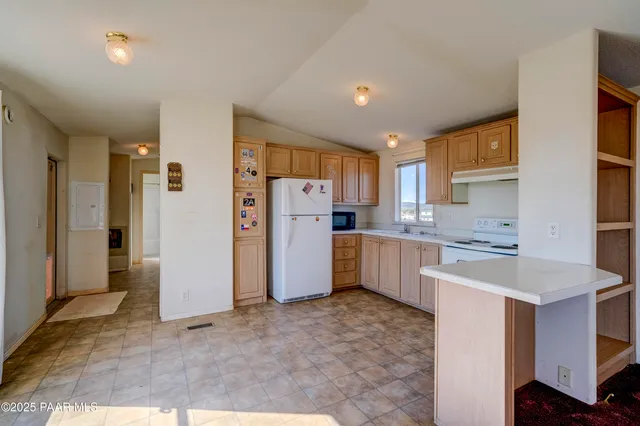 a kitchen with a refrigerator sink stove and cabinets