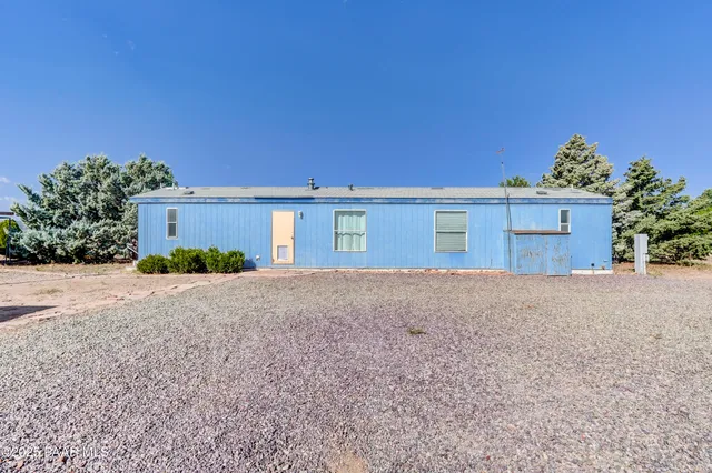 front view of a house with a yard and a garage
