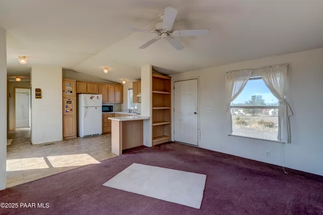 a view of kitchen with refrigerator and window
