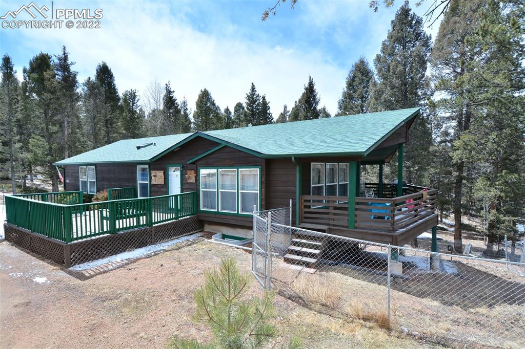 a front view of a house with wooden fence