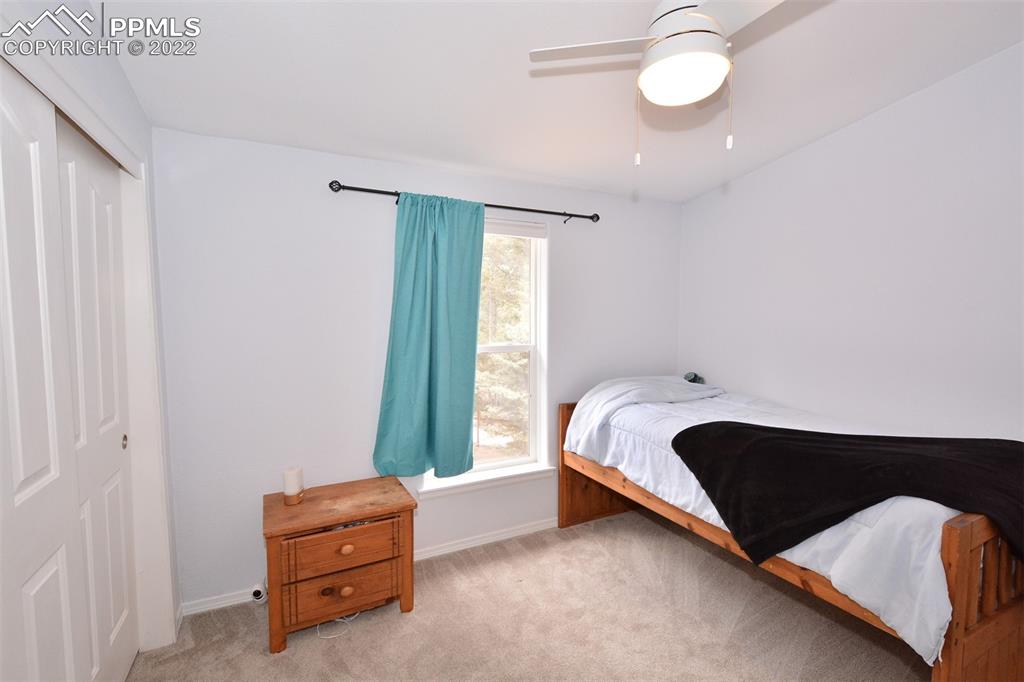 123 Pawutsy Road Florissant, CO 80816 - Photo 15 of 30 a bed sitting in a bedroom next to a window