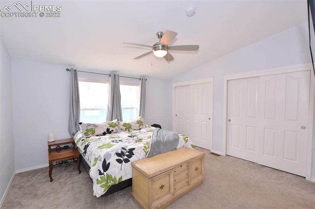 123 Pawutsy Road Florissant, CO 80816 - Photo 18 of 30 a bedroom with a bed and a chandelier