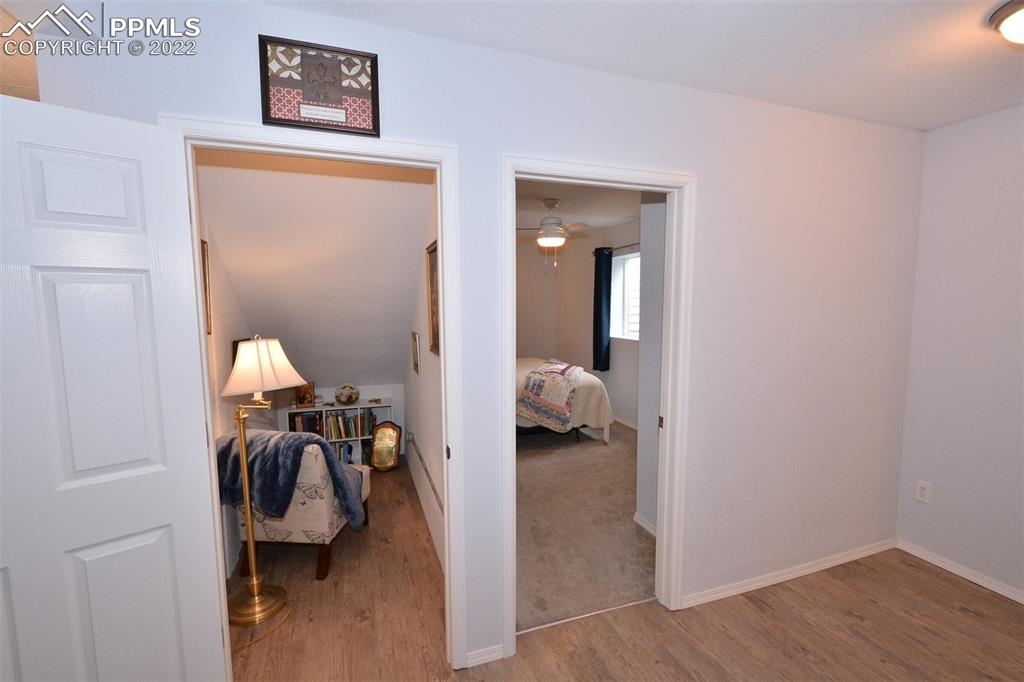 123 Pawutsy Road Florissant, CO 80816 - Photo 25 of 30 a view of a bedroom with a bed and a chandelier
