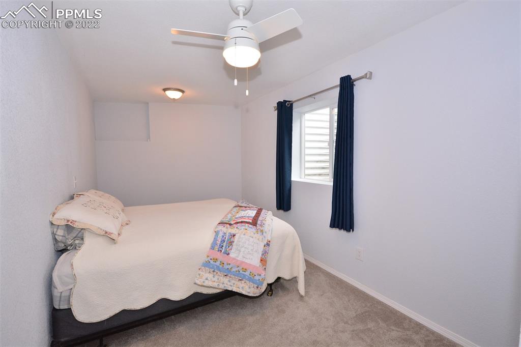 123 Pawutsy Road Florissant, CO 80816 - Photo 29 of 30 a bedroom with a bed and a window