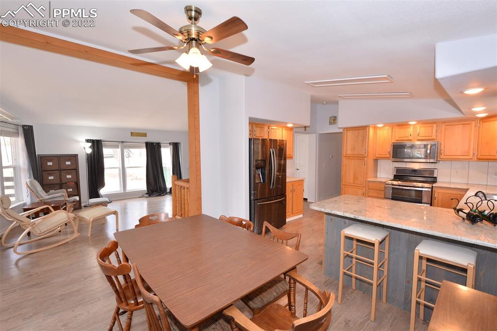 123 Pawutsy Road Florissant, CO 80816 - Photo 9 of 30 a kitchen with a table chairs and a refrigerator