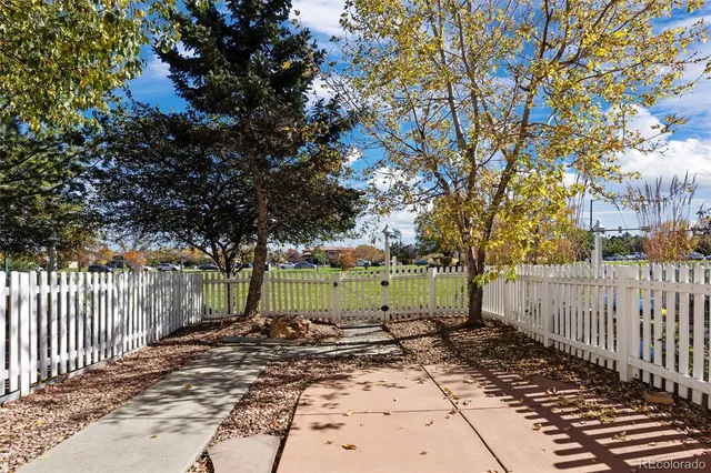 a view of a yard with wooden fence