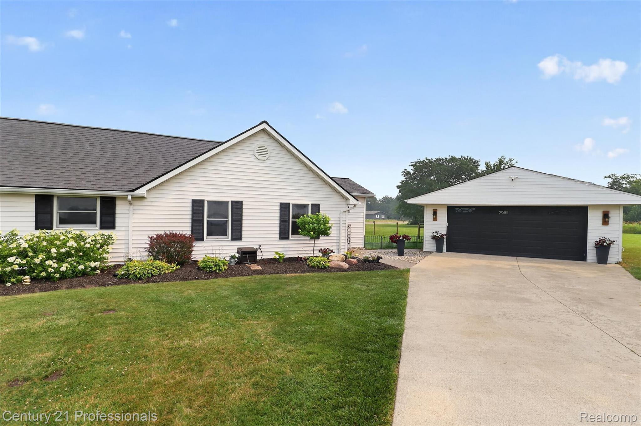 13525 Dennison Road Milan, MI 48160 - Photo 67 of 69 Ranch-style exterior with white vinyl siding, dark shingle roof, and black window shutters
