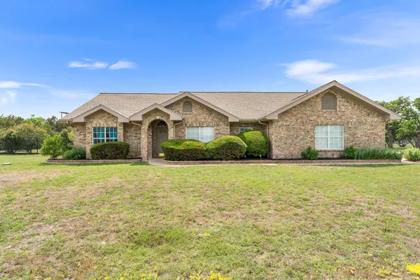 a view of a house with a yard and garage