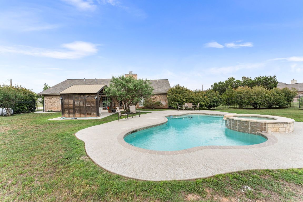 221 Breakaway Road Cedar Park, TX 78613 - Photo 12 of 39 a view of a swimming pool with a yard