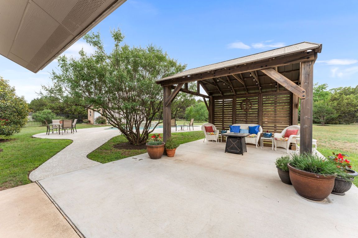 221 Breakaway Road Cedar Park, TX 78613 - Photo 16 of 39 a view of a patio with table and chairs and potted plants