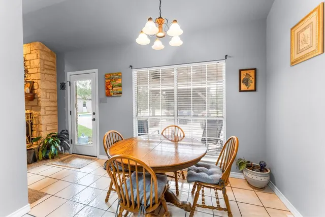 a view of a dining room with furniture and chandelier