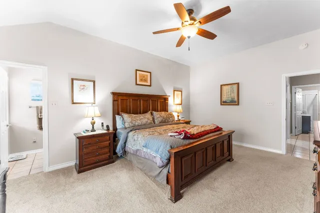 a bedroom with bed and a chandelier
