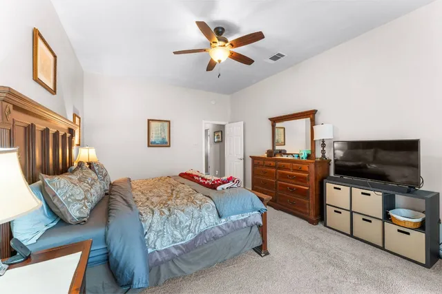 a bedroom with furniture and a flat screen tv