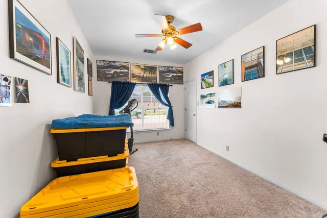 a room with gym equipment and wooden floor