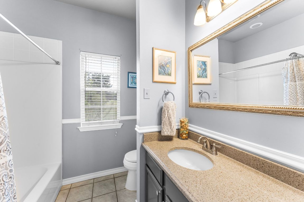 221 Breakaway Road Cedar Park, TX 78613 - Photo 37 of 39 a bathroom with a granite countertop sink toilet and a mirror