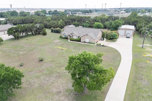 an aerial view of a house with pool