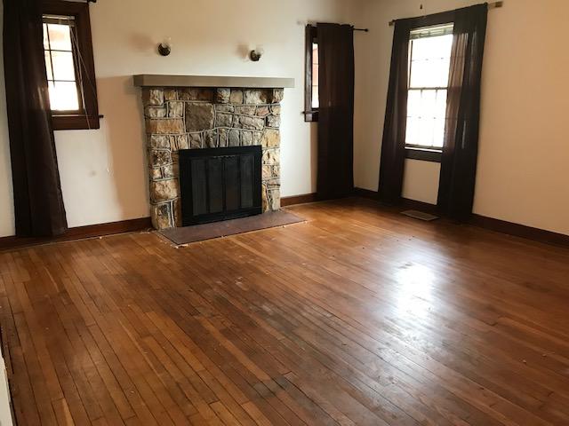 313 Turner Road Salem, VA 24153 - Photo 3 of 15 an empty room with wooden floor fireplace and windows