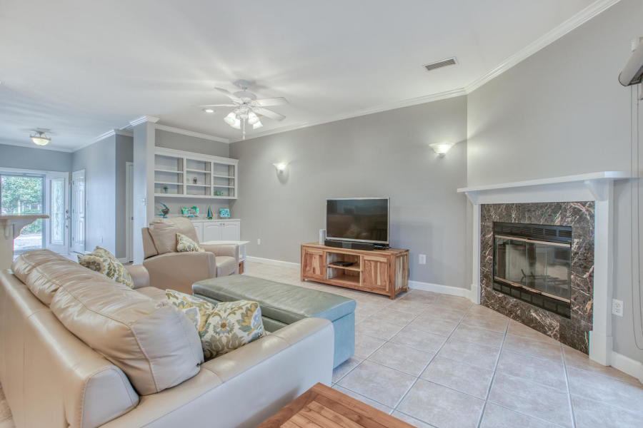 377 Ridge Road Santa Rosa Beach, FL 32459 - Photo 2 of 46 a living room with furniture a fireplace and a flat screen tv
