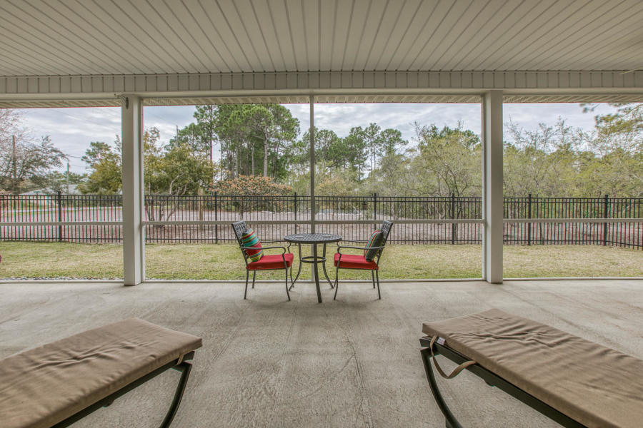 377 Ridge Road Santa Rosa Beach, FL 32459 - Photo 14 of 46 a view of a porch with chairs and backyard